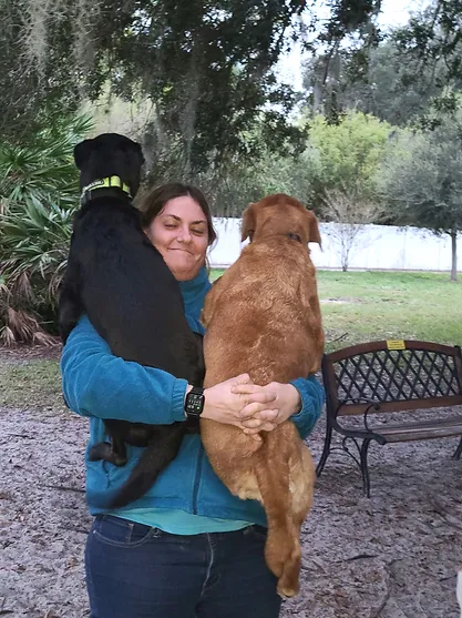 lady holding 2 dogs